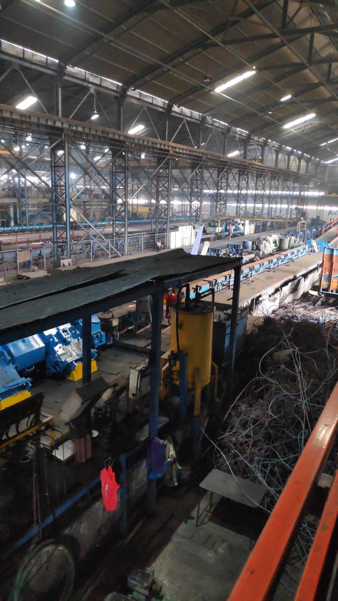 Large factory floor overview — blue industrial machinery
